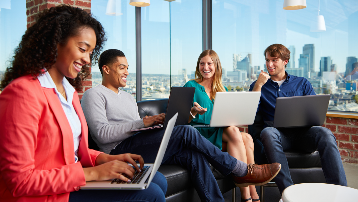 Positive marketing team collaborating around a table in a bright office